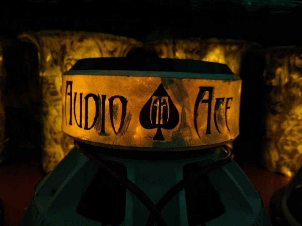 Close-up on glow in the dark speaker with Audio Ace logo on it