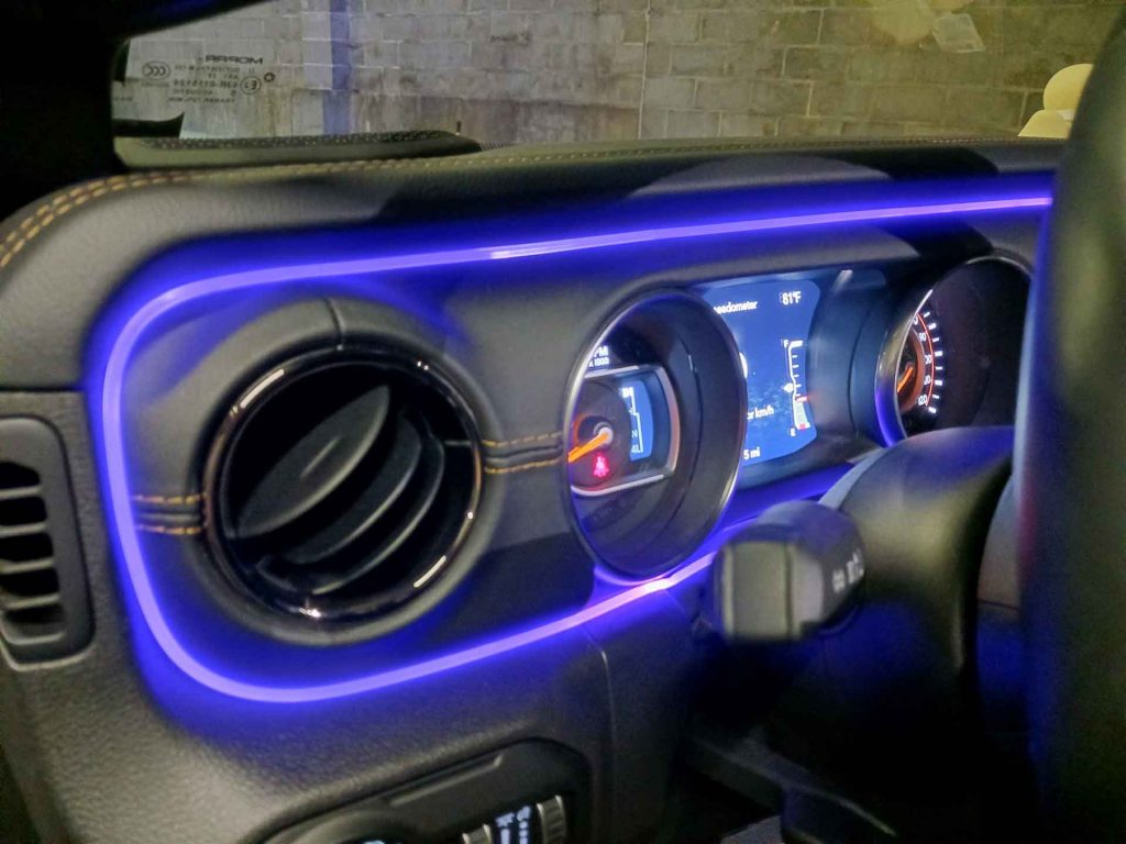 Close-up shot of car dashboard with blue custom lighting
