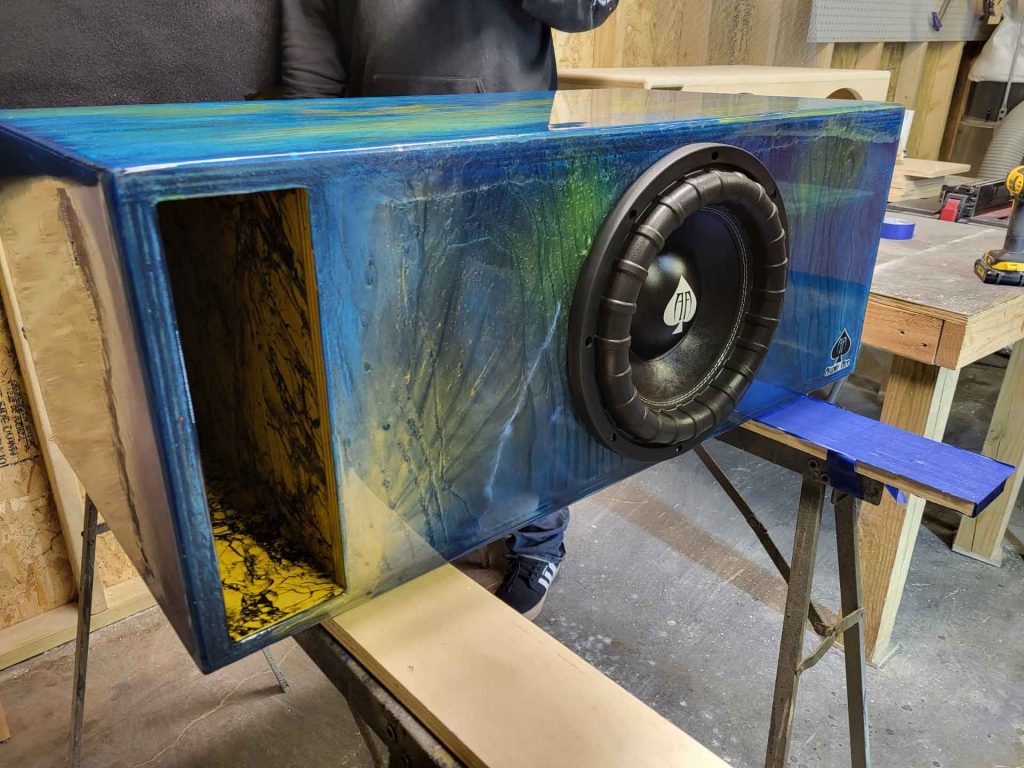 Car speaker with blue and yellow marbled paint job