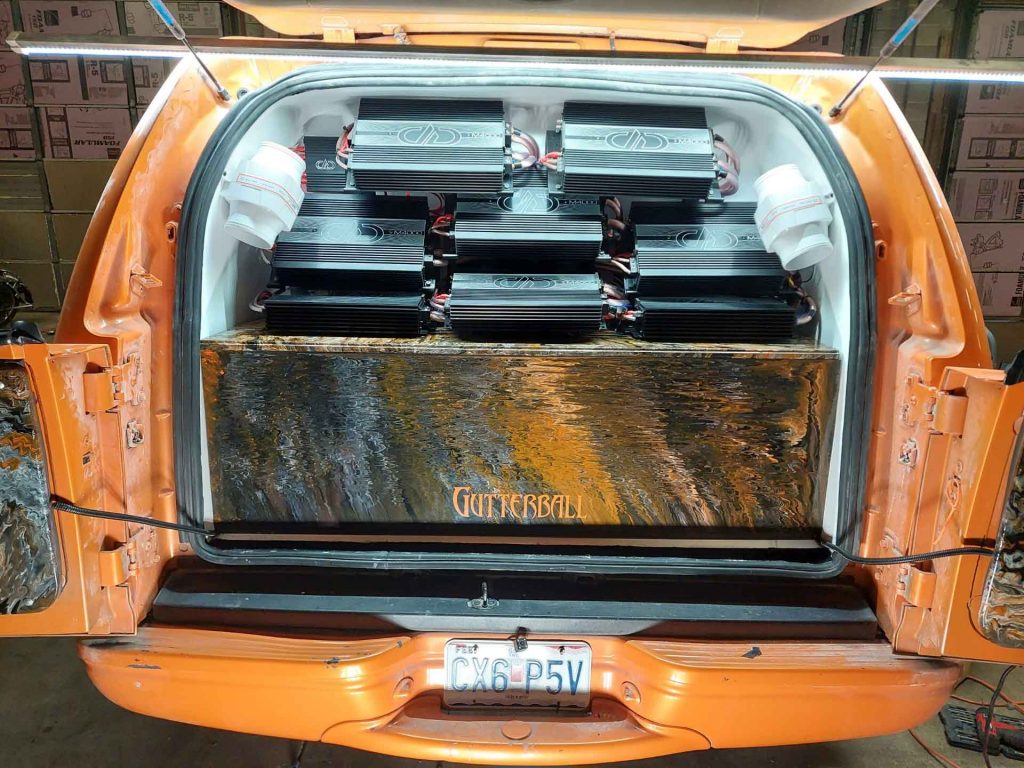 Large speaker system in the back of an orange car