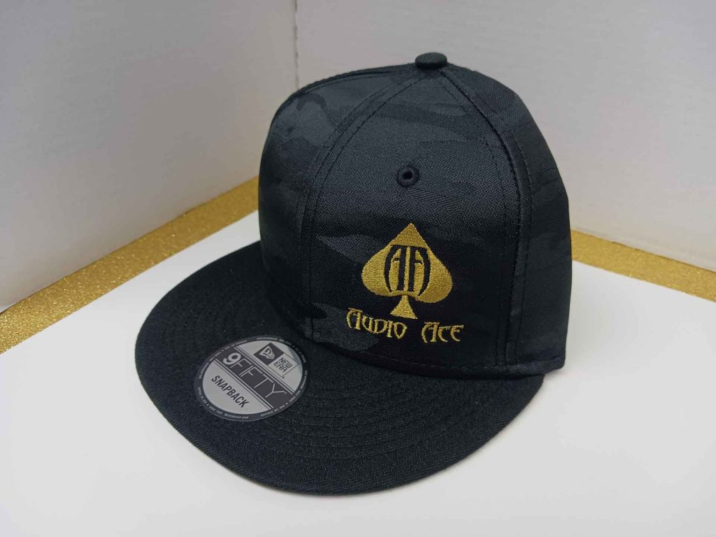 Black snap-back hat with Audio Ace logo embroidered in gold