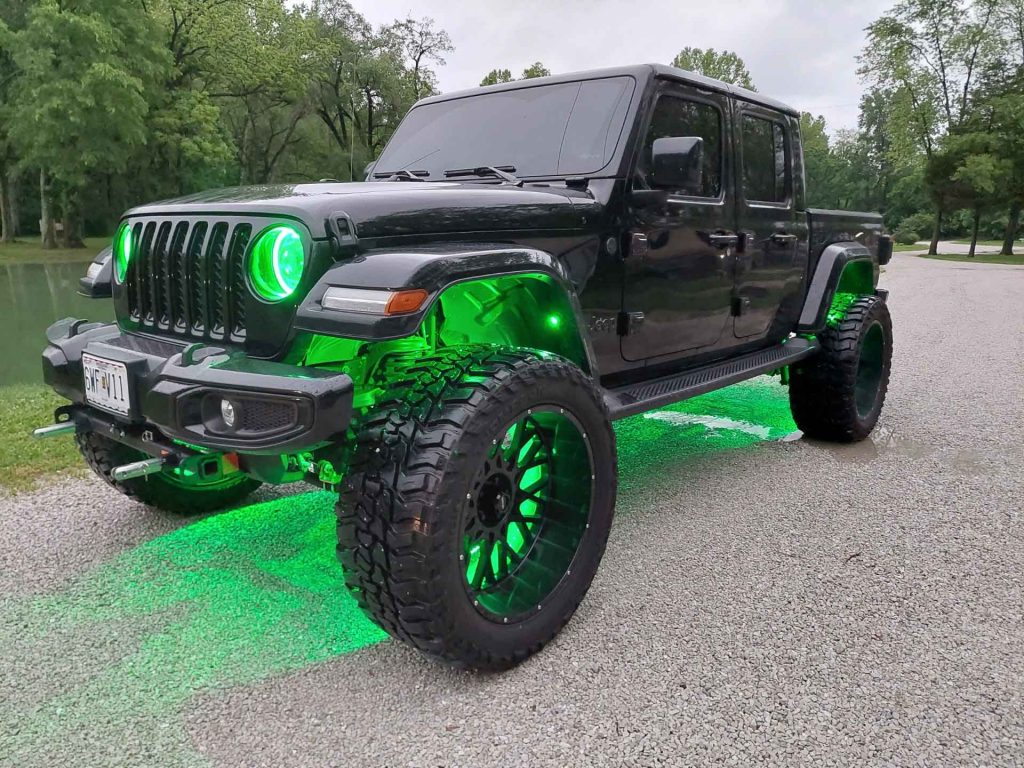Black jeep with green custom lighting