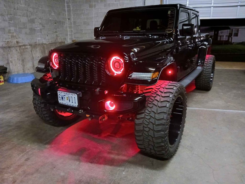 Black Jeep with red custom lighting