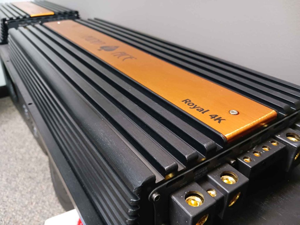 Close-up on a speaker with the Audio Ace logo printed on it