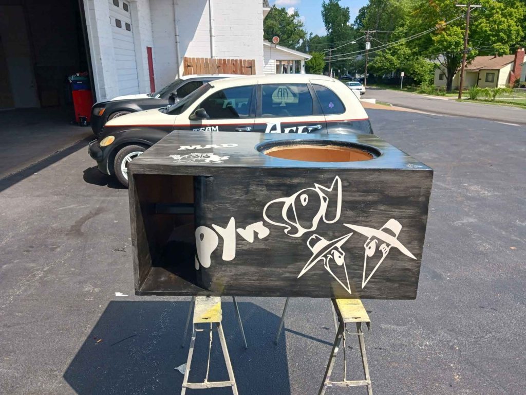 Wooden case for a car audio system with the Spy Vs Spy characters from Mad Magazine painted on it