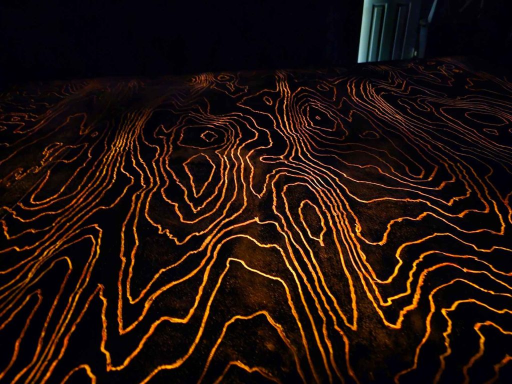 Speaker with glow in the dark wood grain texture